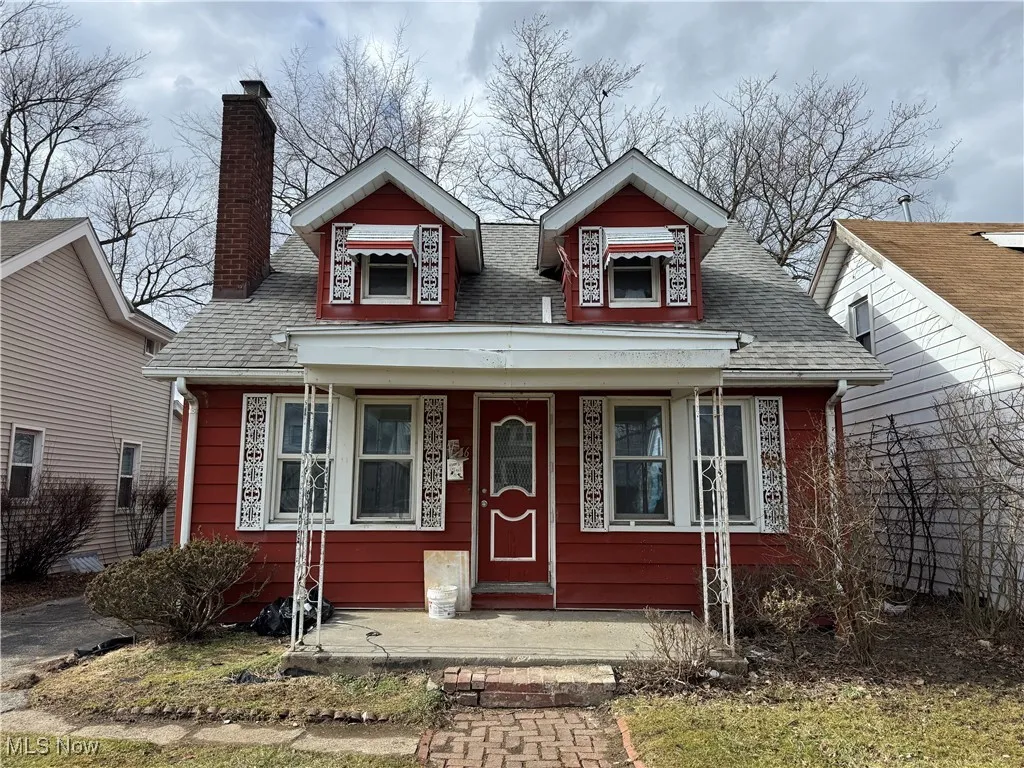 Bungalow-style home featuring a porch, a chimney, and a shingled roof