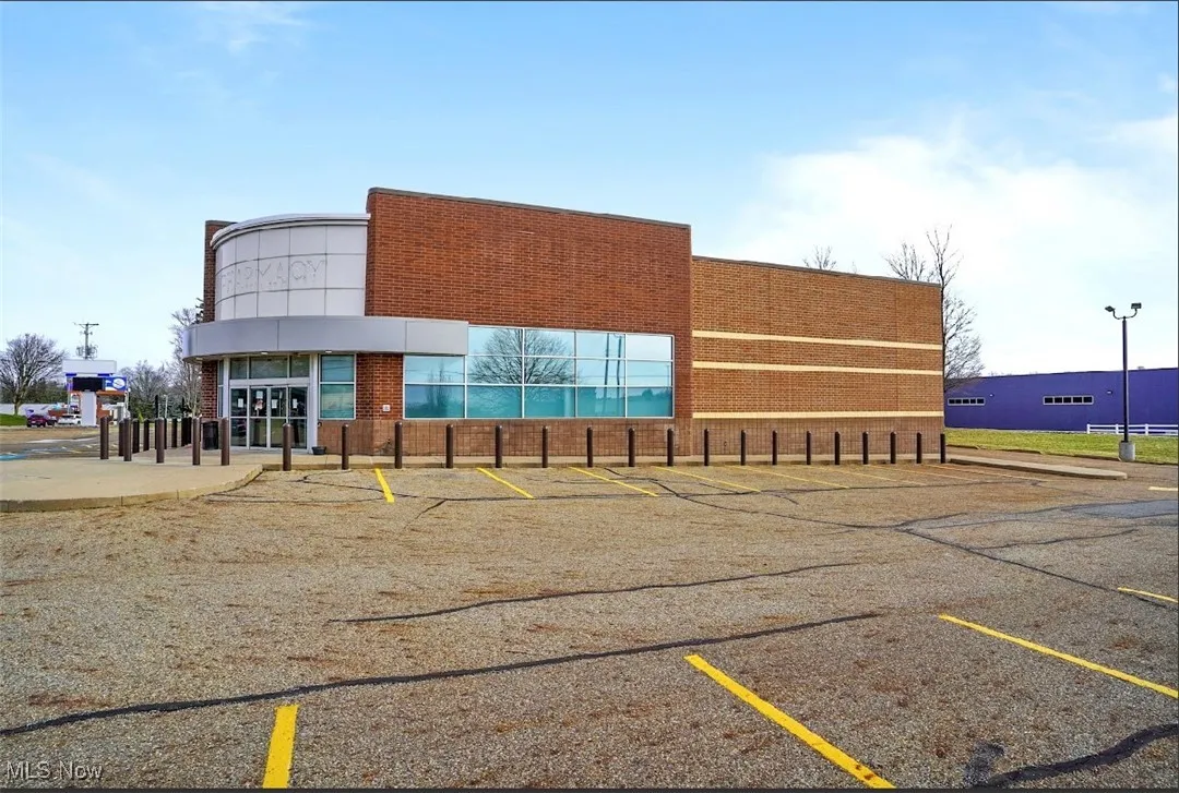 View of property with uncovered parking