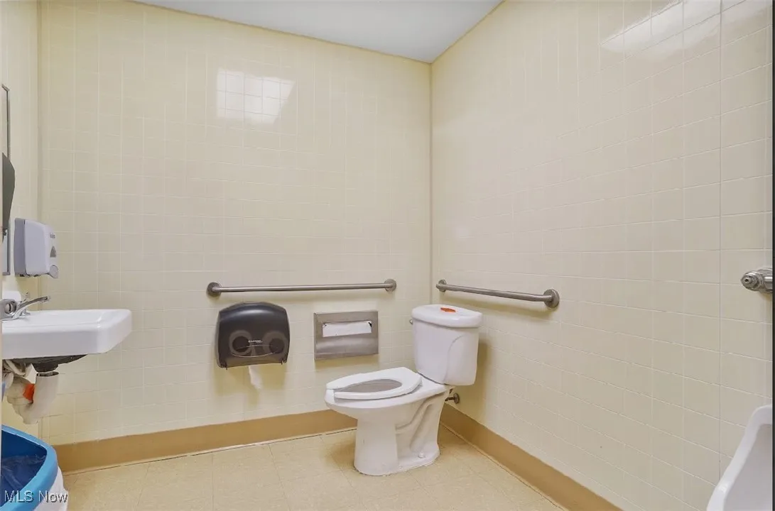 Bathroom with tile walls and toilet