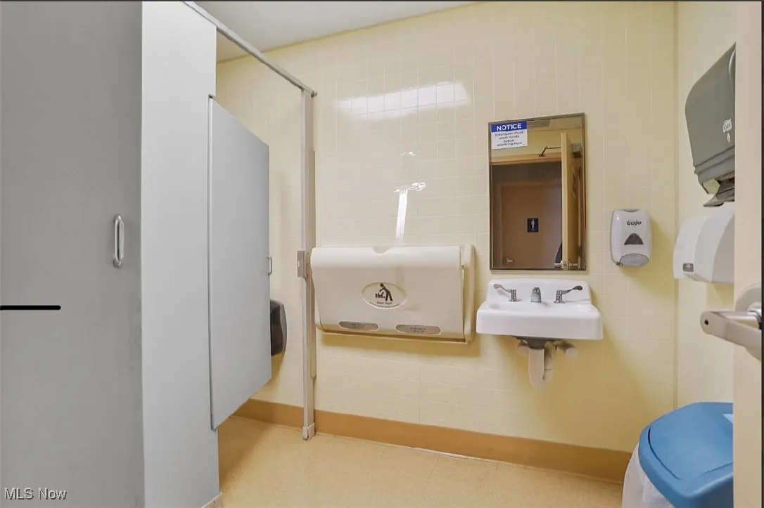 Bathroom with tile walls and a sink