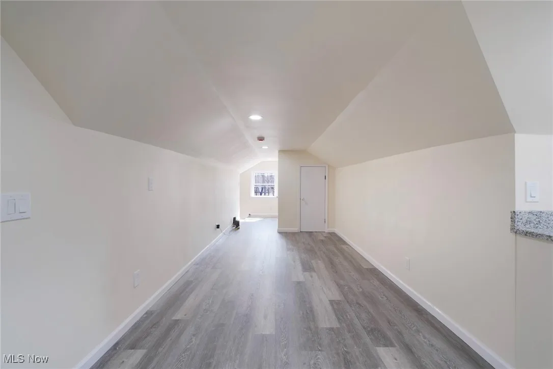 Bonus room featuring lofted ceiling, wood finished floors, and​​‌​​​​‌​​‌‌​‌‌​​​‌‌​‌​‌​‌​​​‌​​ baseboards