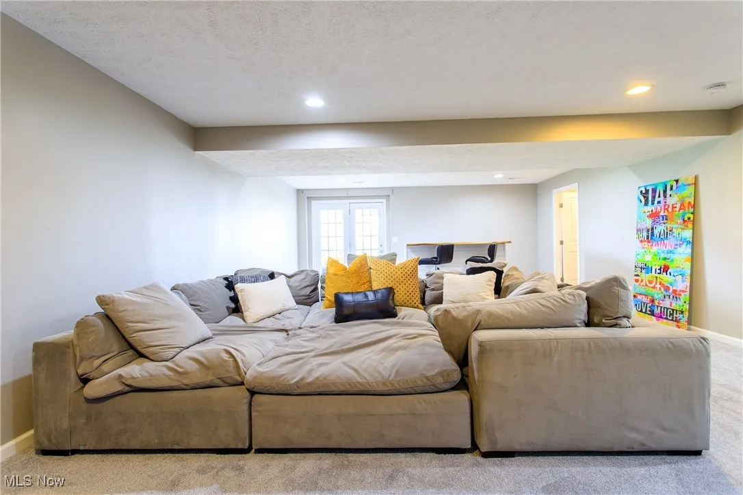 Carpeted living room featuring baseboards and recessed lighting