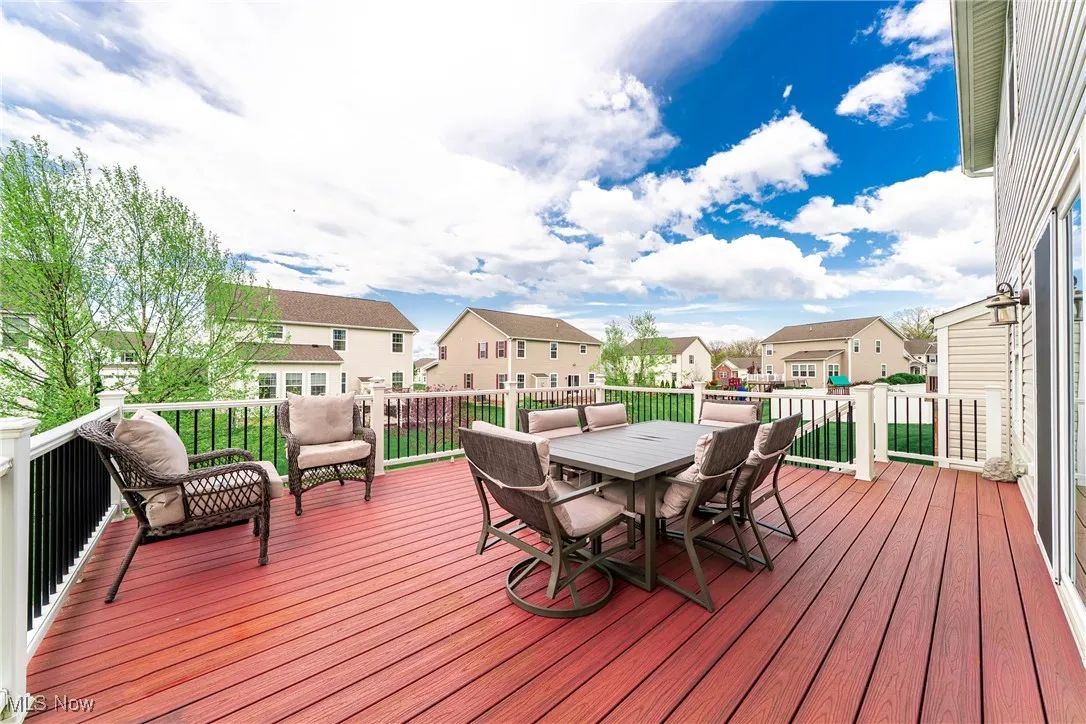 Deck featuring outdoor dining space and a residential view