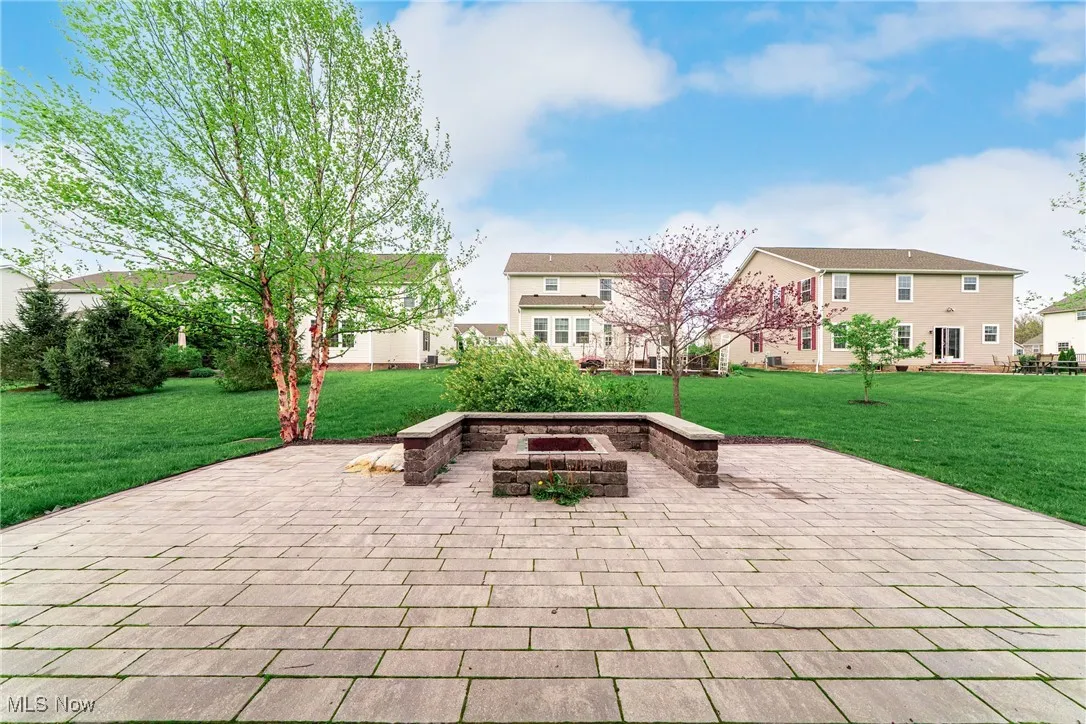 View of patio featuring an outdoor fire pit and a residential view