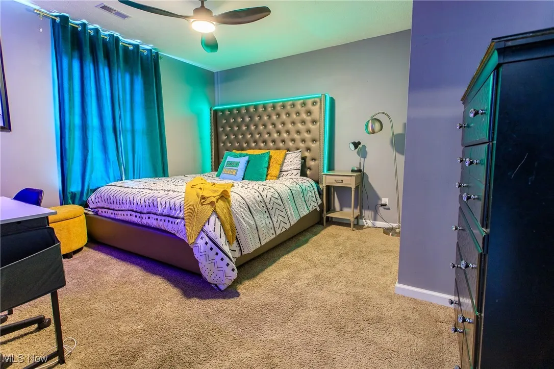 Bedroom with carpet flooring, baseboards, and ceiling fan