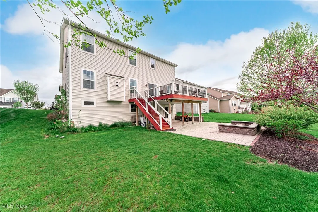 Back of house with a patio, a deck, stairs, and a yard