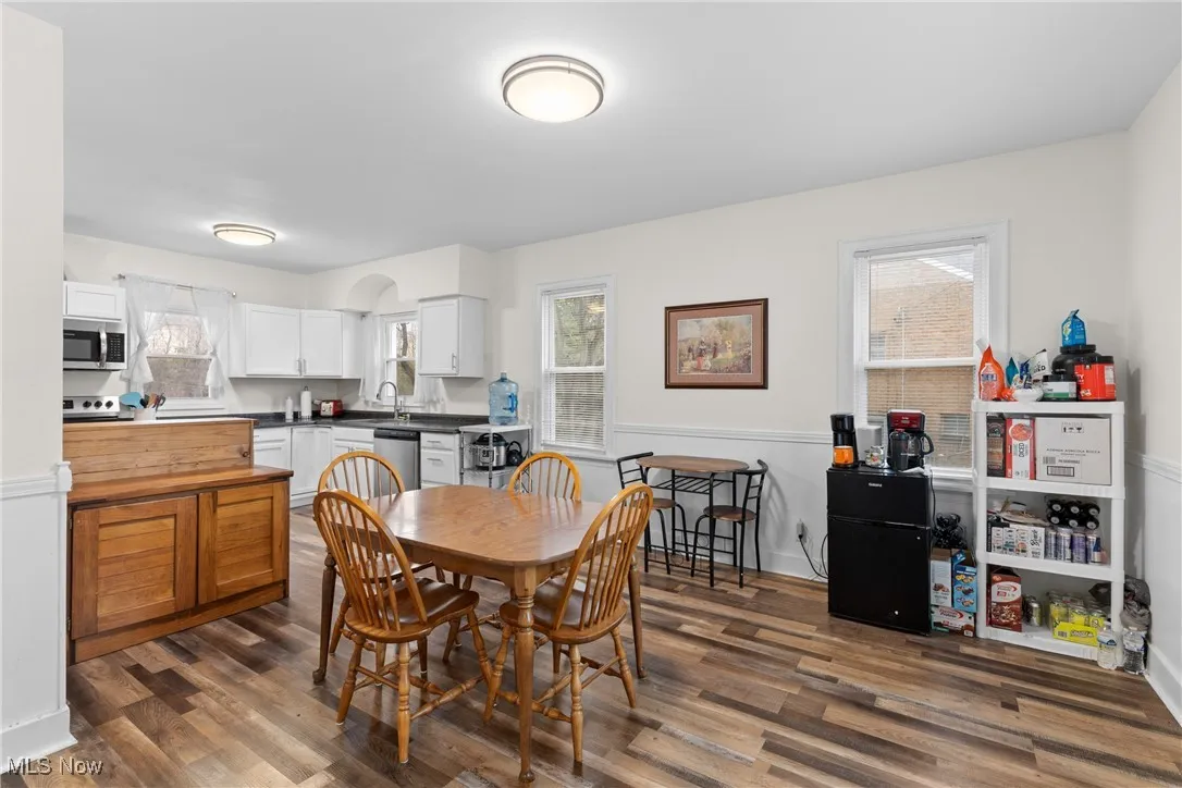 Dining space featuring dark wood finished floors and baseboards