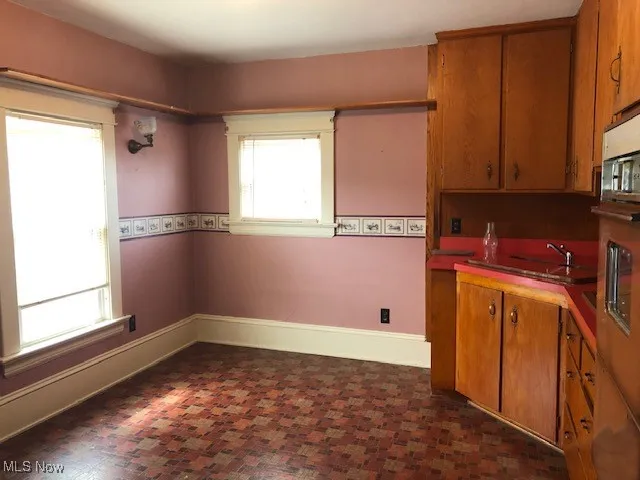 Kitchen featuring brown cabinets and baseboards