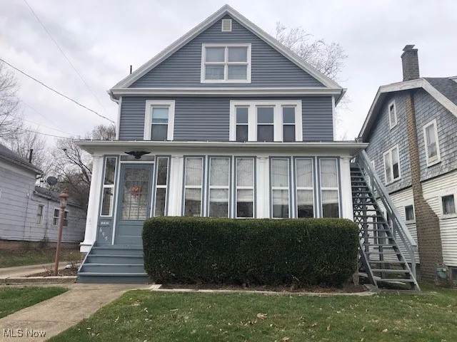 American foursquare style home featuring stairs and entry steps
