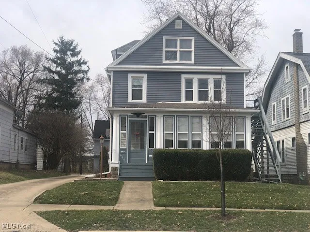 American foursquare style home with a front yard