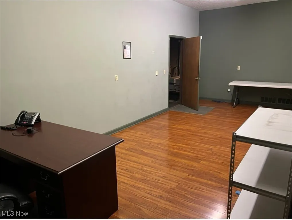 Office space with visible vents and wood finished floors