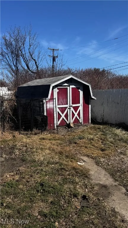 View of shed featuring fence