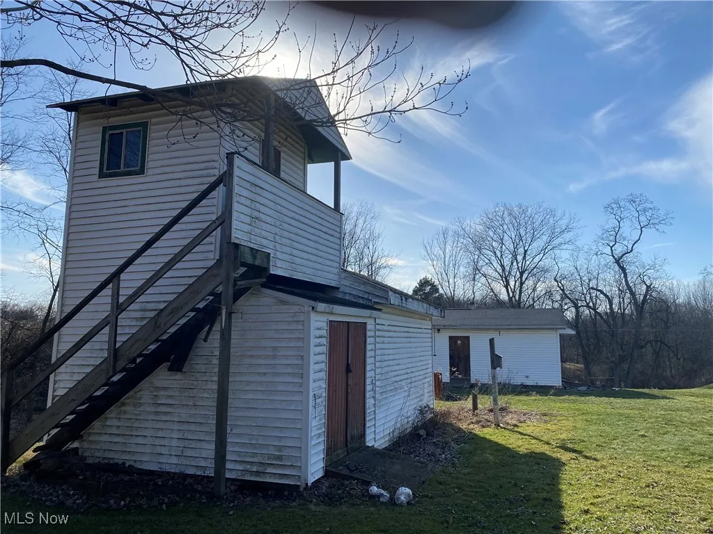 View of outbuilding featuring stairway