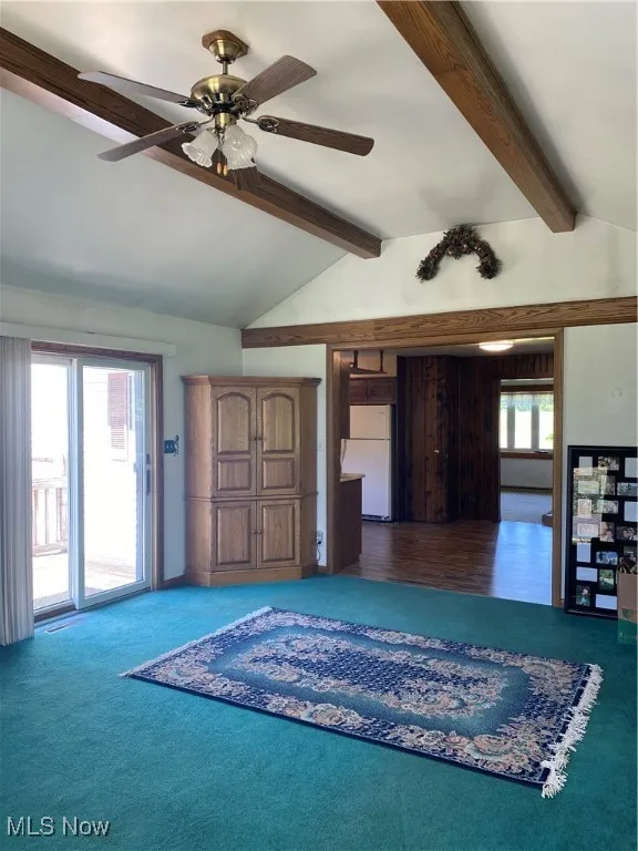 Unfurnished living room with carpet and ceiling fan