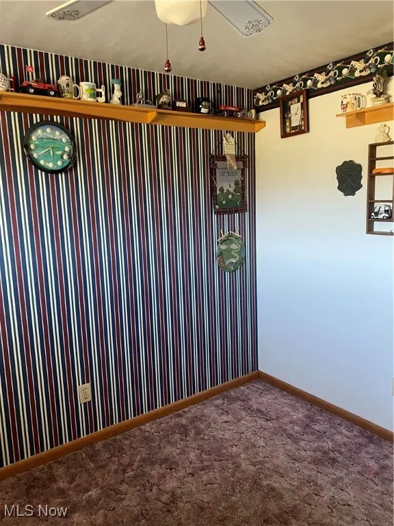 Carpeted empty room with baseboards