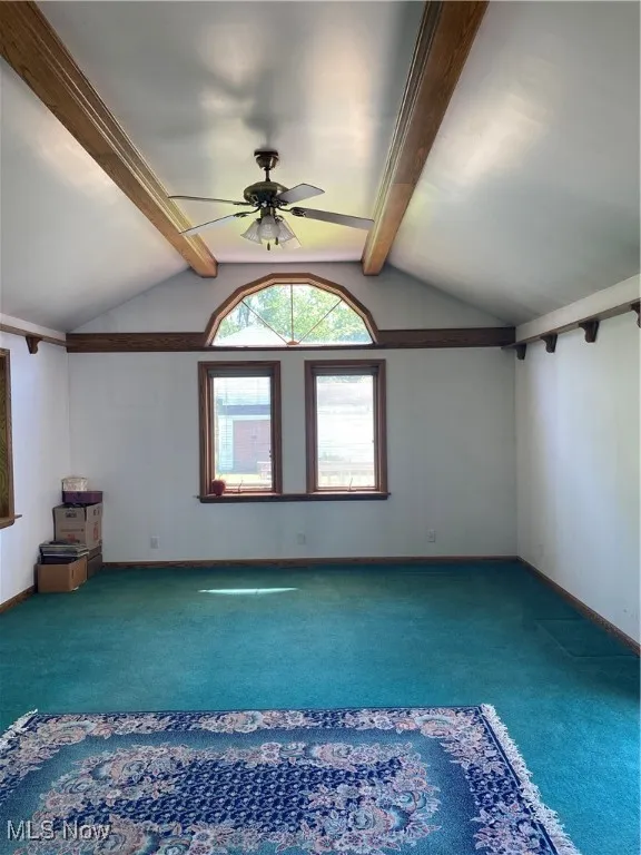 Empty room featuring carpet, a ceiling fan, and baseboards