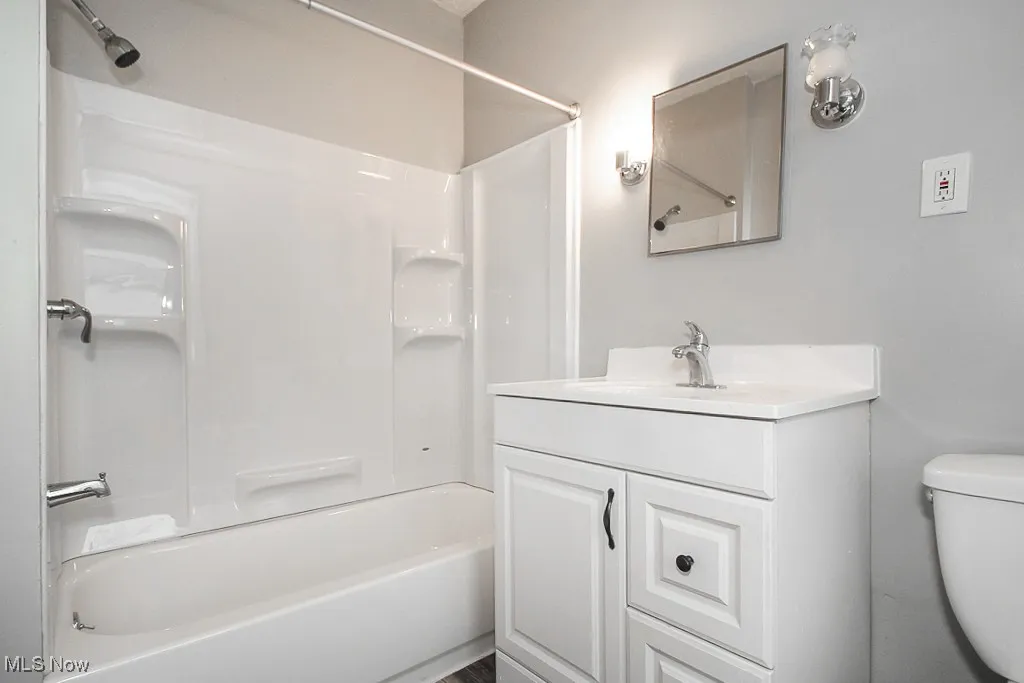 Full bath with bathtub / shower combination, toilet, and vanity
