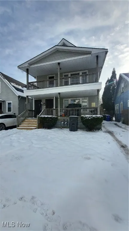 View of front of house featuring a balcony and a porch