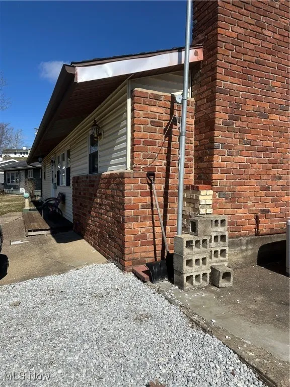 View of side of property with brick siding