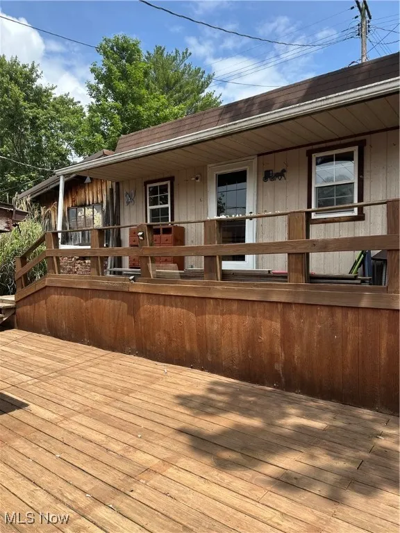 View of wooden deck and additional She shed or man care
