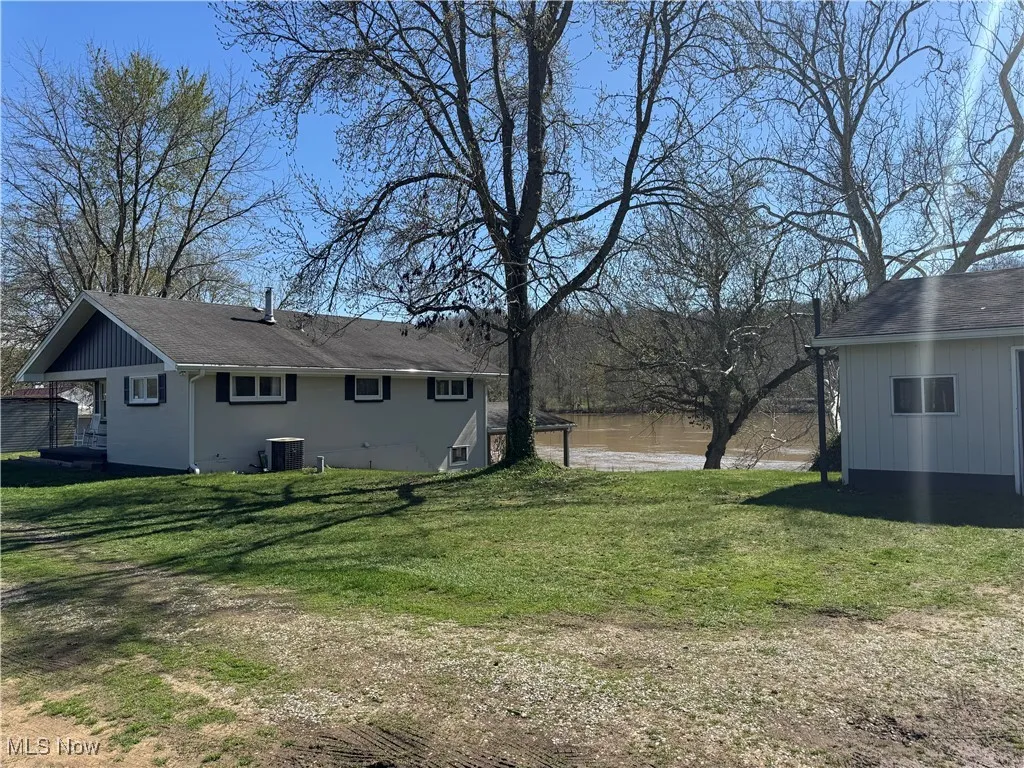 View of yard featuring a water view and central AC