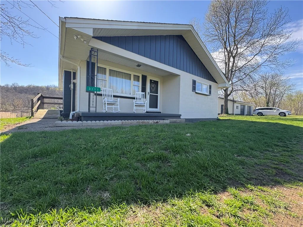 View of front of house with a front lawn and covered porch