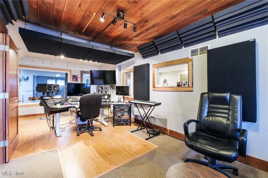 Office with visible vents, track lighting, baseboards, wooden ceiling, and wood finished floors