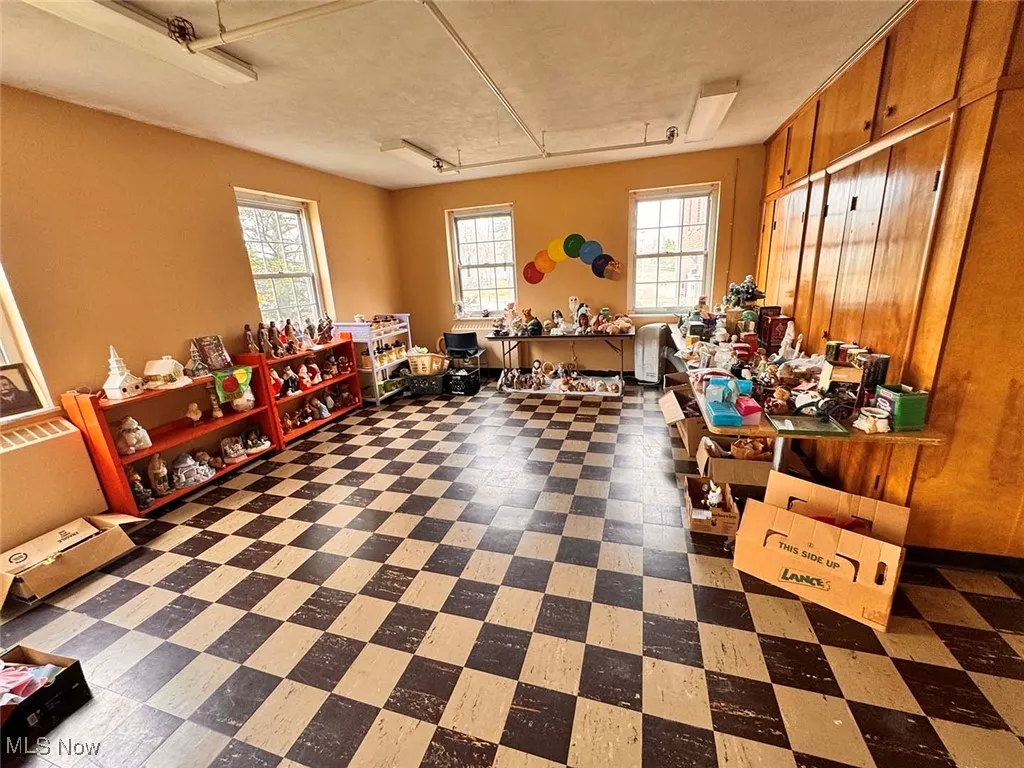 Misc room featuring tile patterned floors and plenty of natural light