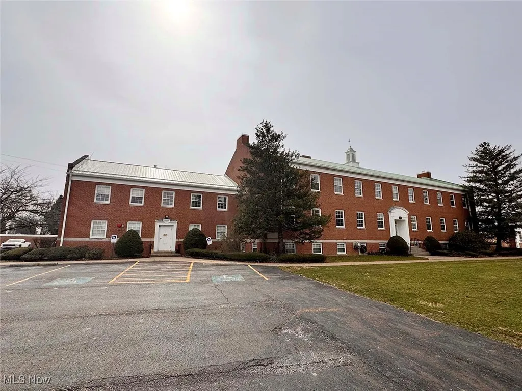 View of property with uncovered parking