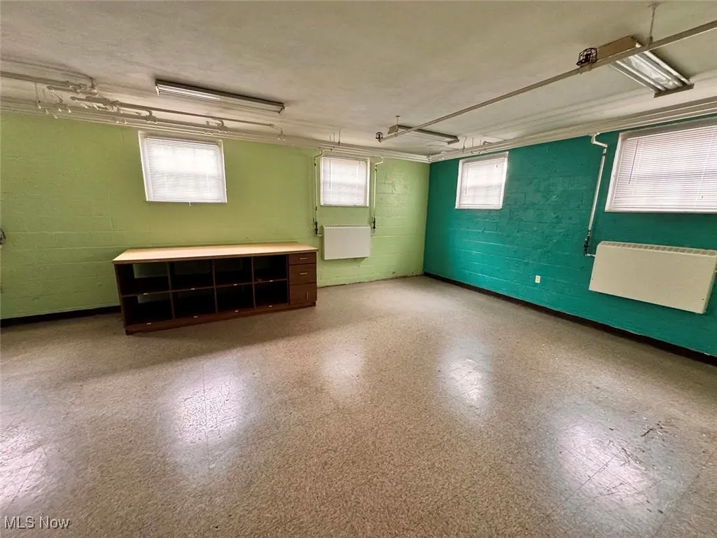 Below grade area with tile patterned floors and concrete block wall