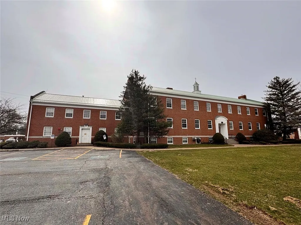 View of property with uncovered parking