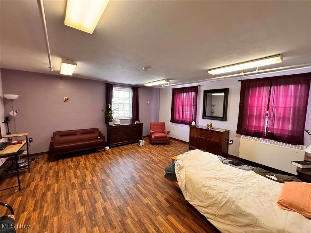 Bedroom with baseboards and wood finished floors