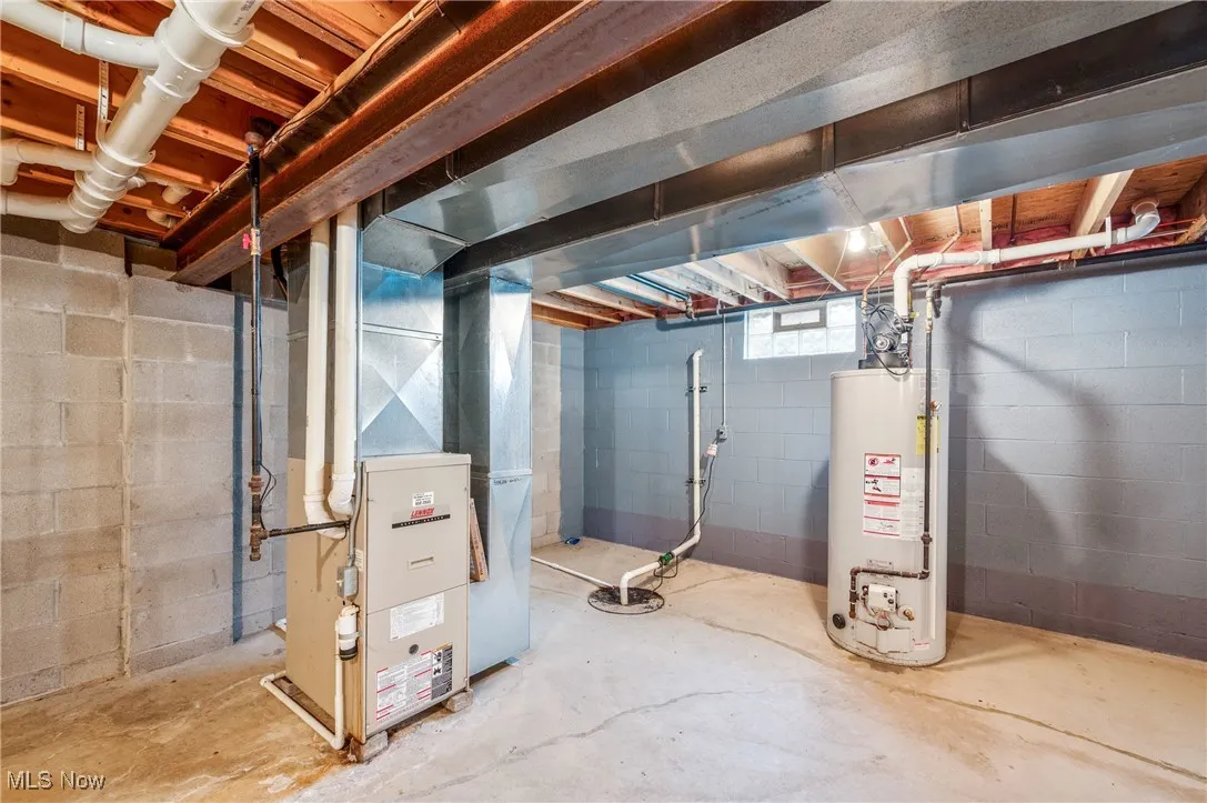 Below grade area with heating unit and gas water heater