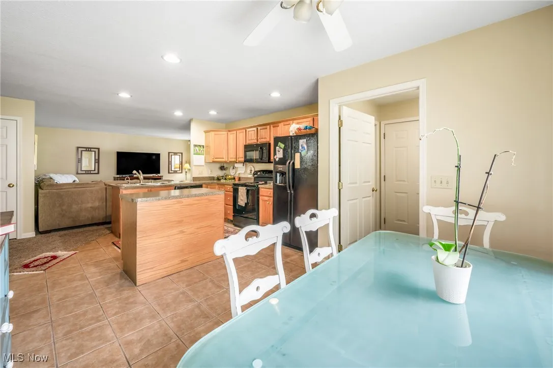 Dining space with a ceiling fan, recessed lighting, and light tile patterned floors