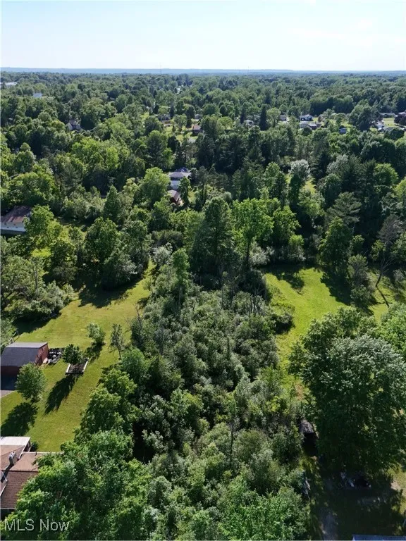 Aerial view featuring a forest view