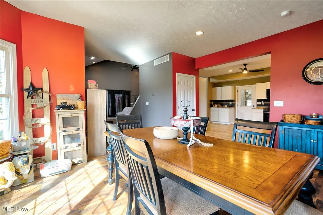 Dining room with plenty of natural light, visible vents, recessed lighting, and a ceiling fan