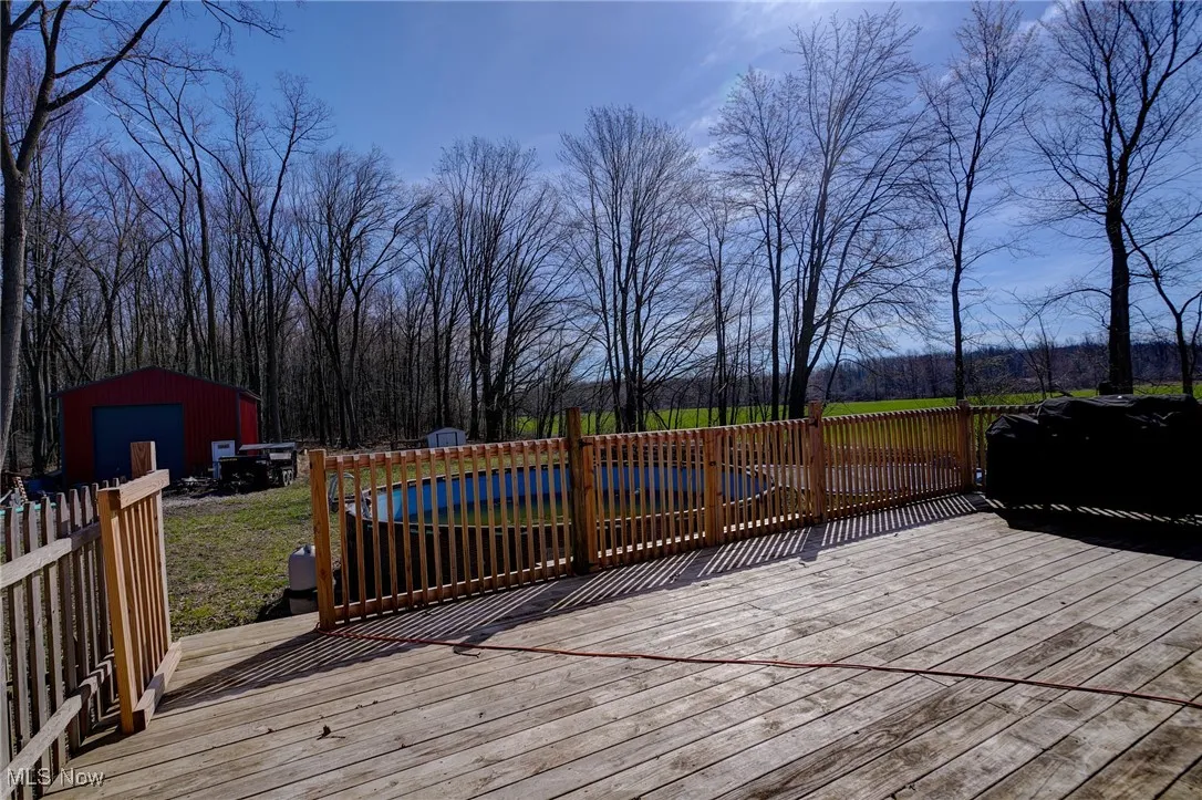 Deck featuring an outdoor structure and a swimming pool