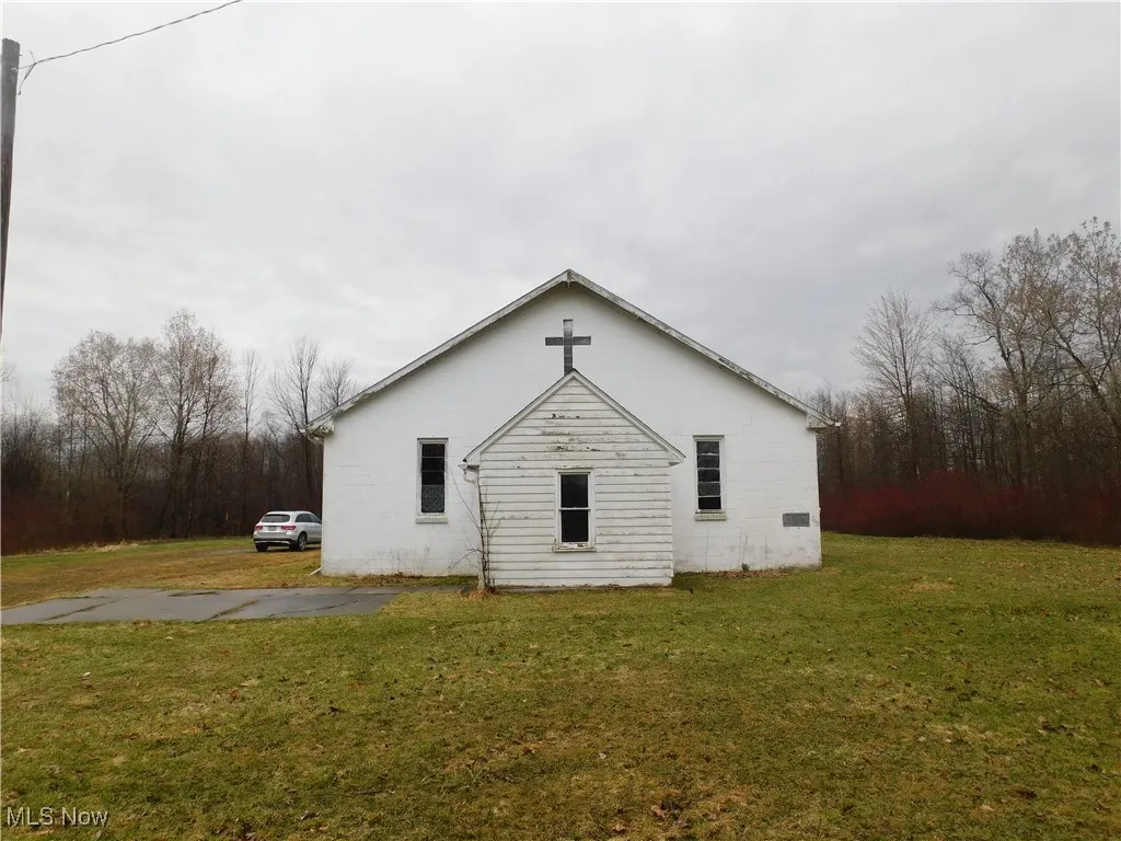 View of property exterior with a lawn