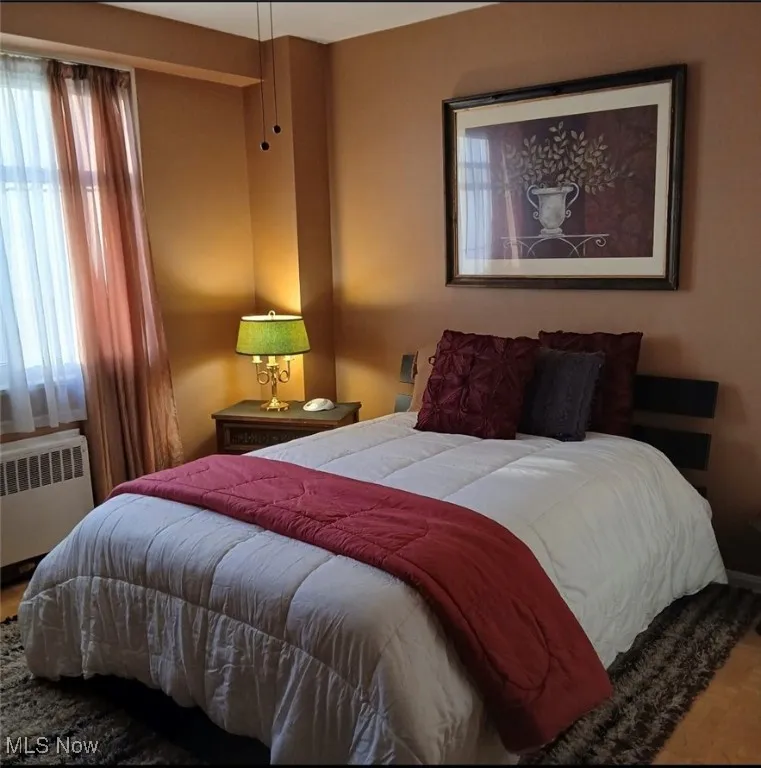 Bedroom with radiator heating unit