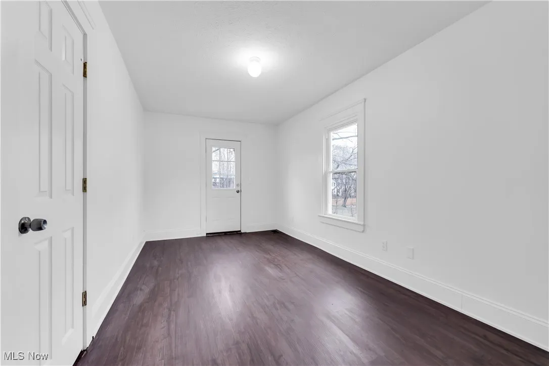 Entrance foyer featuring dark wood-type flooring and baseboards
