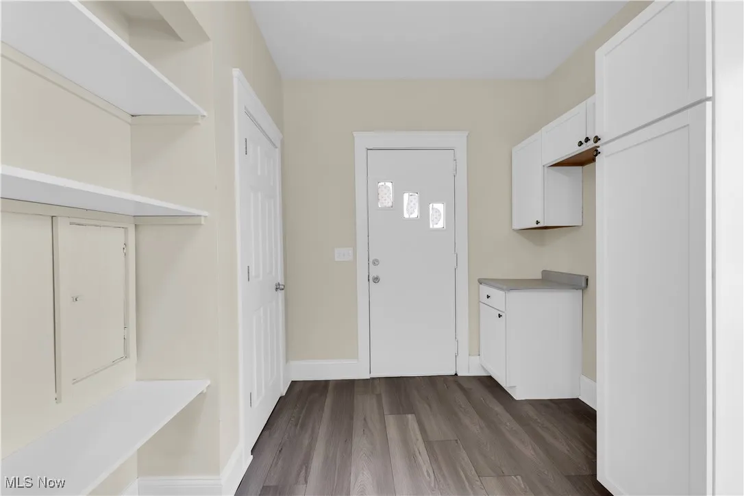 Dark wood-style flooring and baseboards