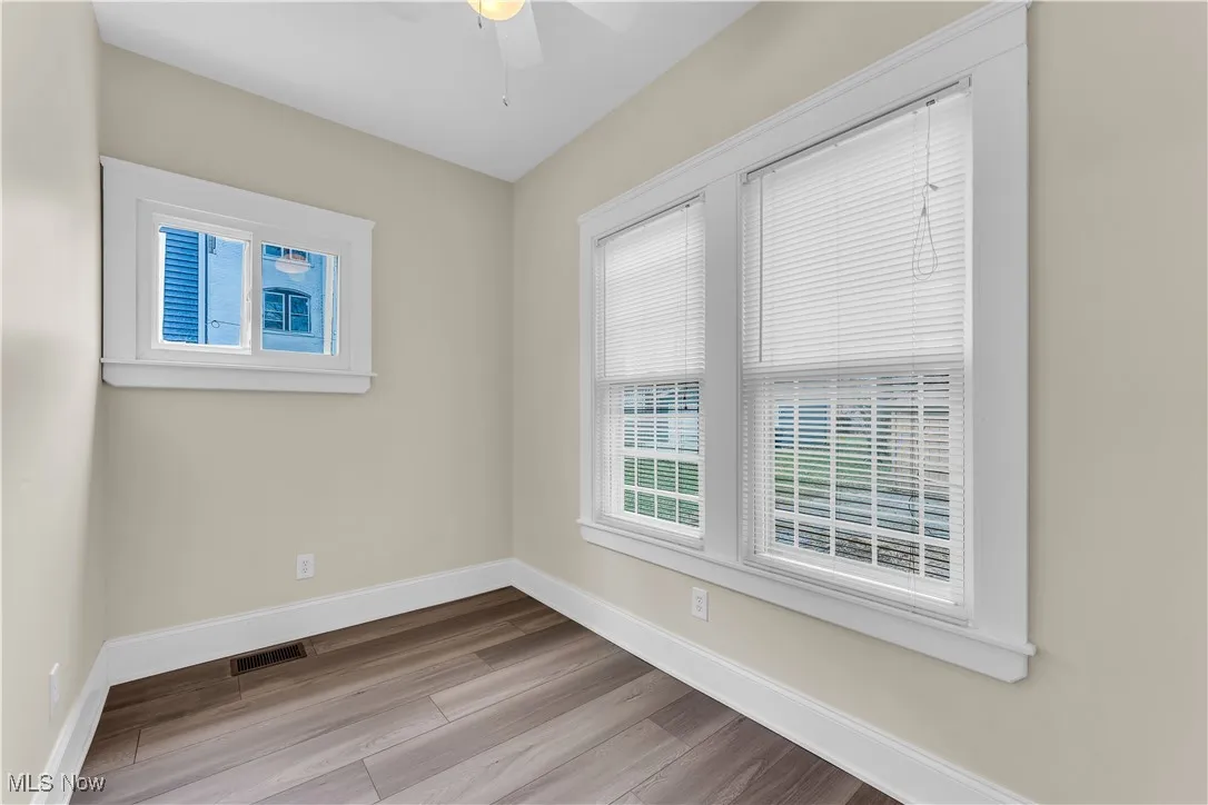 Spare room featuring baseboards, visible vents, ceiling fan, and wood finished​​‌​​​​‌​​‌‌​‌‌​​​‌‌​‌​‌​‌​​​‌​​ floors