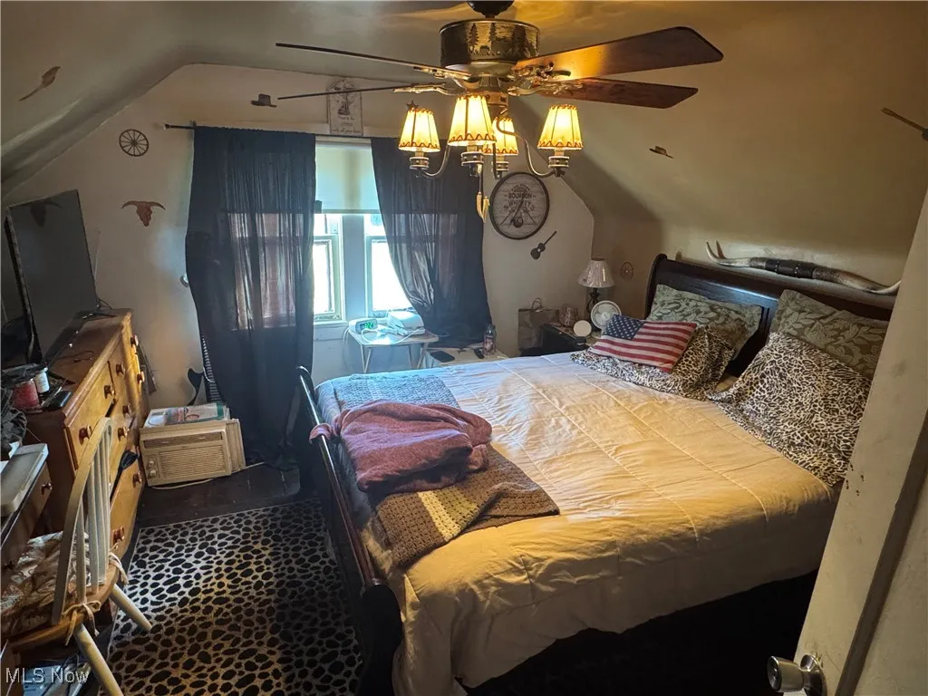 Bedroom featuring lofted ceiling and ceiling fan