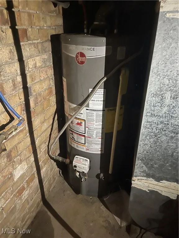 Utility room featuring gas water heater