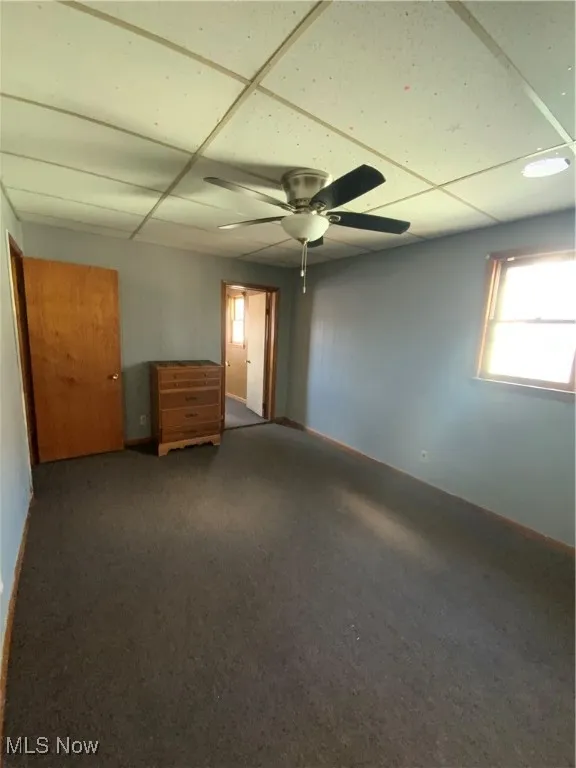 Empty room featuring a ceiling fan
