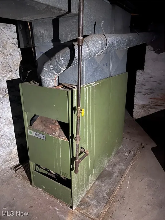 Utility room featuring heating unit