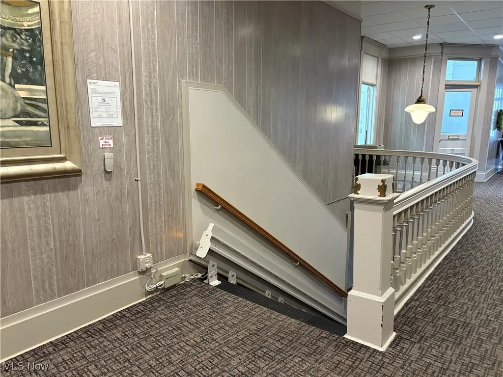 Stairs with carpet and a drop ceiling