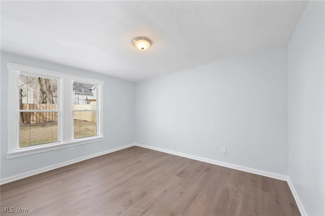 Bedroom featuring baseboards and wood style floors