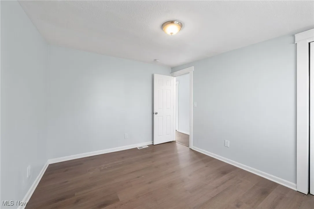 Bedroom featuring, baseboards, and wood style floors