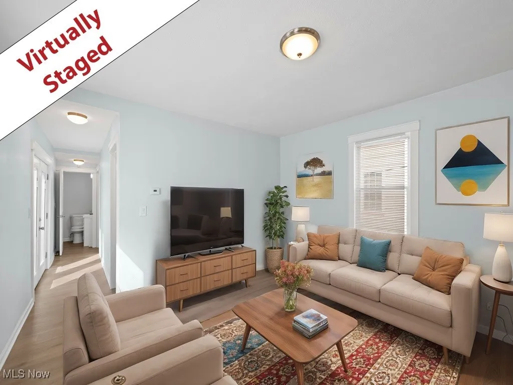 Living room featuring light wood-style floors and baseboards